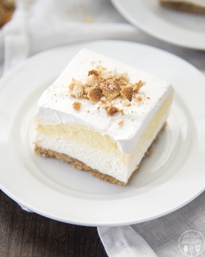 A banana bream pie bar on a plate topped with vanilla wafer crumbs. 