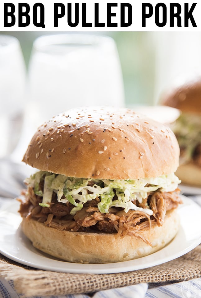 A slow cooker bbq pulled pork sandwich on a white plate. 