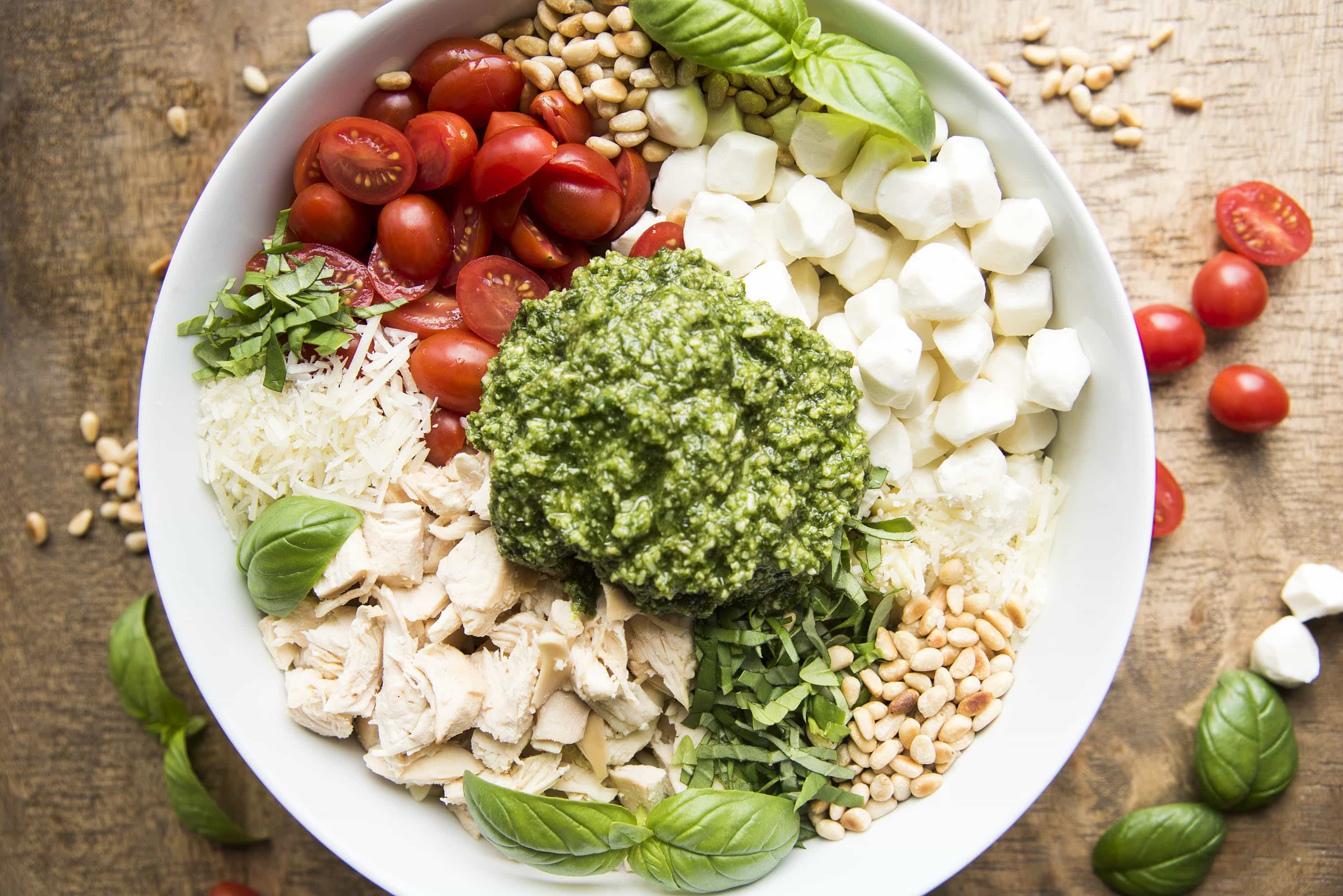This pesto pasta salad can be easy to make with store bought pesto, rotisserie chicken, and mozzarella pearls! 