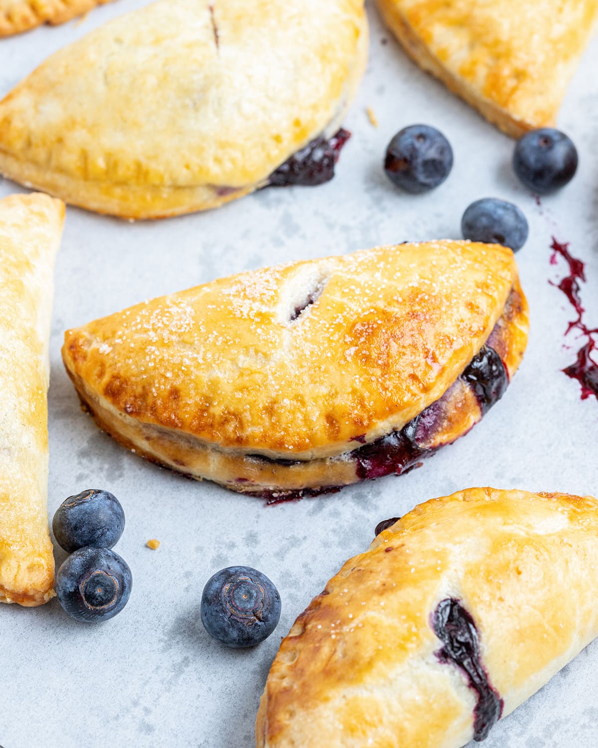A close up of half circle blueberry hand pies.
