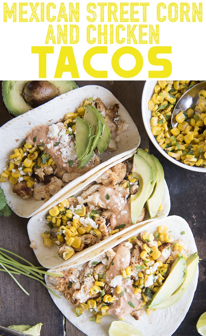 Three mexican street corn and chicken tacos topped with cotija and avocado slices.