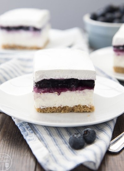 A piece of no bake blueberry cheesecake on a white plate.