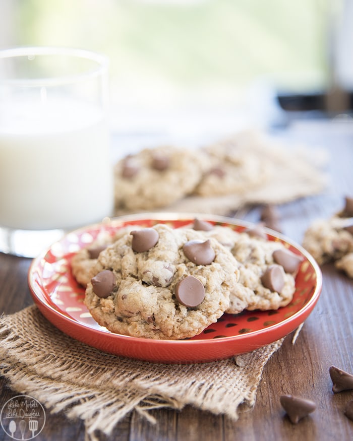 Oatmeal chocolate chip cookies on a red plate.