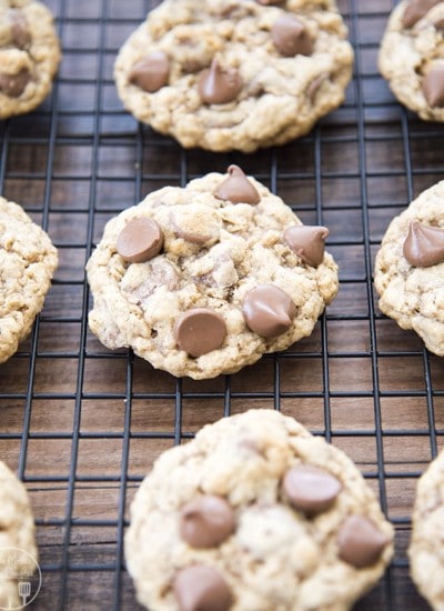 Oatmeal chocolate chip cookies on a cooling rack.