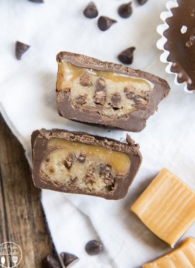 A caramel and cookie dough cup cut in half showing the middle.