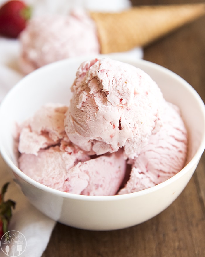 A close up of a bowl of strawberry ice cream.