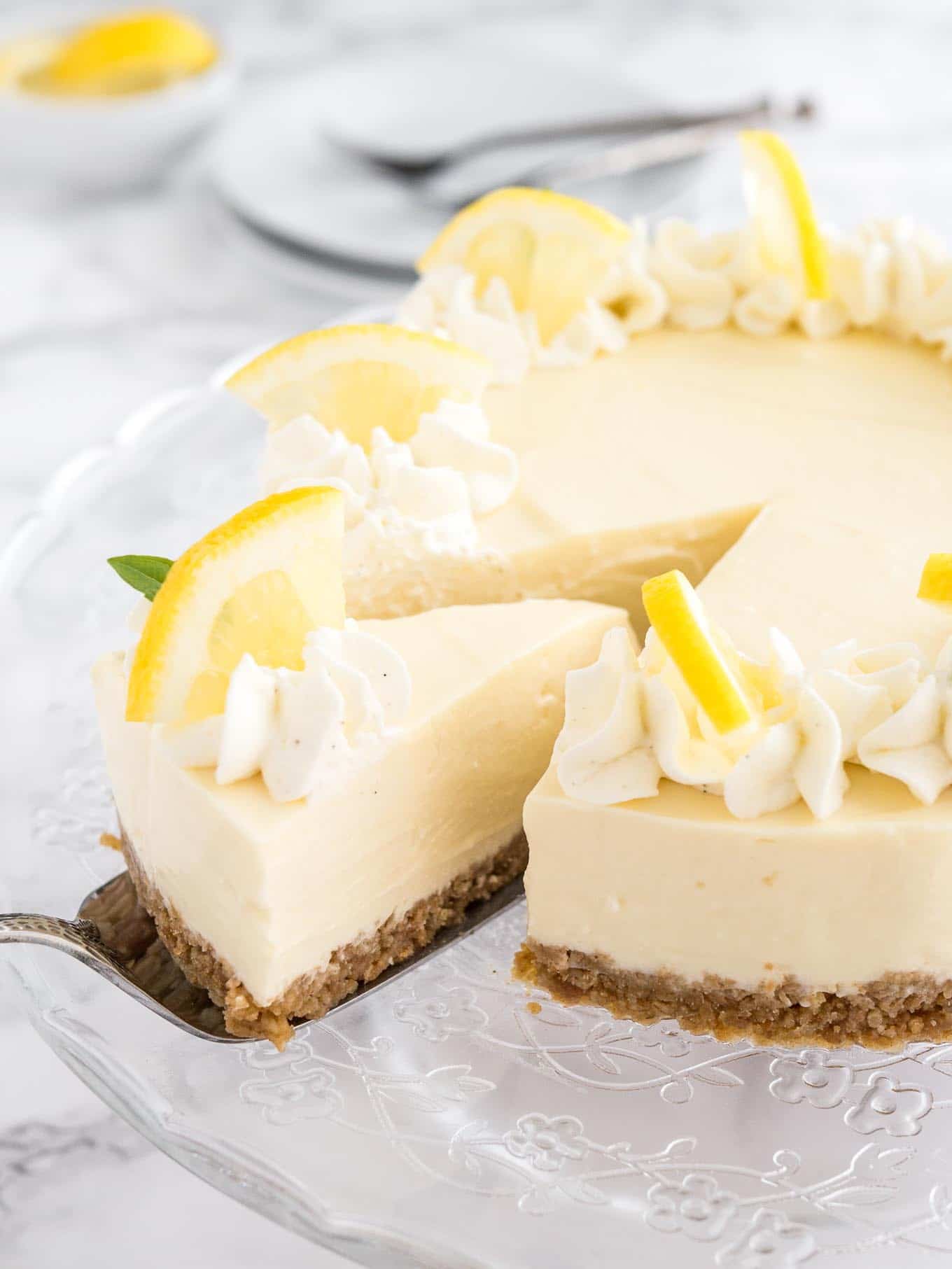A slice of no bake lemon cream pie with lemon wedges over the top. 