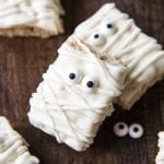 Mummy Rice Krispie Treats decorated with white chocolate chips and candy eyes.