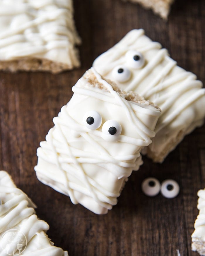 Mummy Rice Krispie Treats decorated with white chocolate chips and candy eyes.