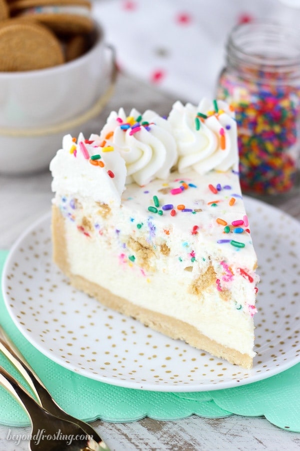 A slice of no bake funfetti pie with sprinkles and whipped cream.