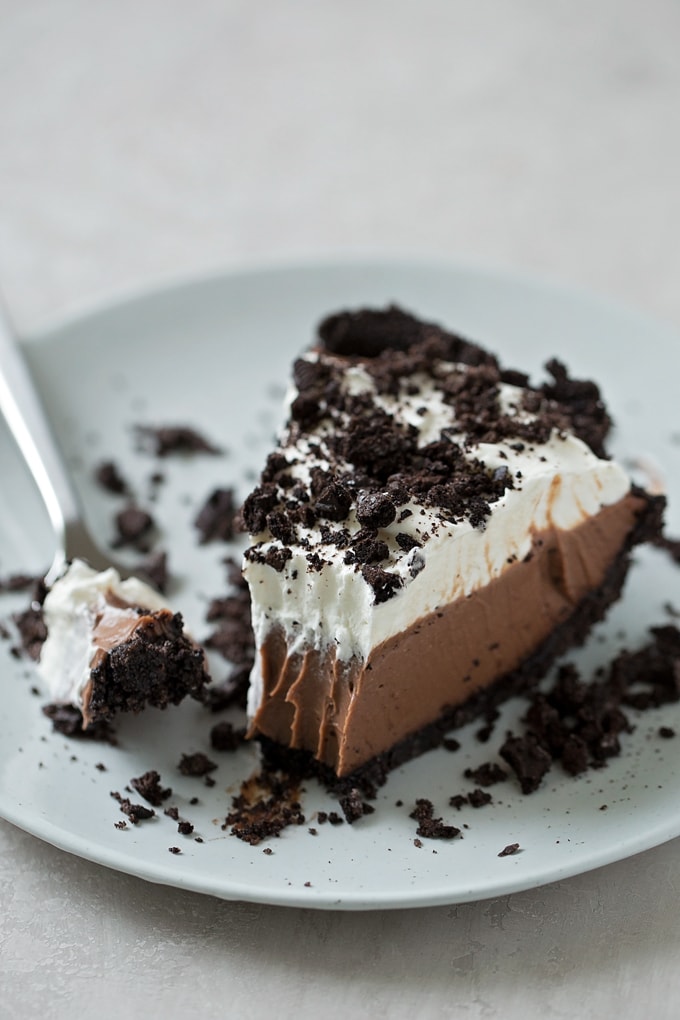 A slice of no bake mud pie on a plate with a forkful cut out. 