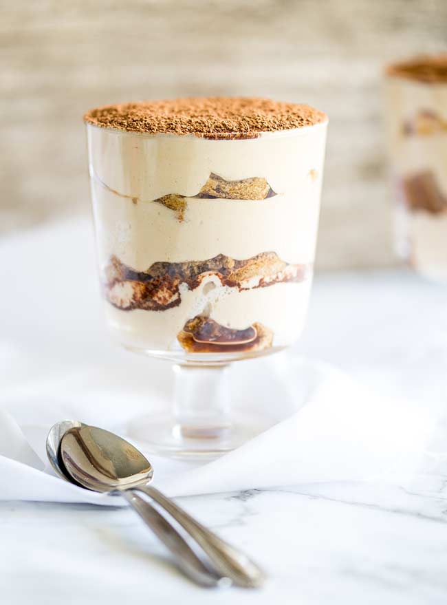 A tiramisu trifle in a glass cup. 