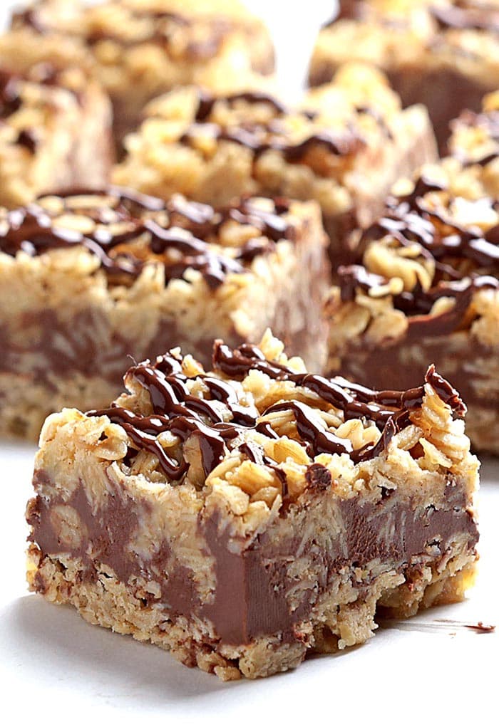 Chocolate caramel oatmeal bars with chocolate drizzled over the top. 