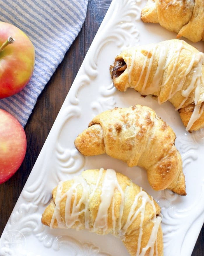 Apple pie crescent rolls decorated with icing over the top.
