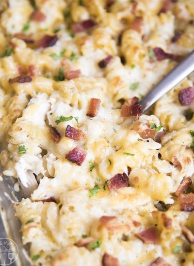 A chicken bacon ranch casserole topped with cheese and bacon pieces.