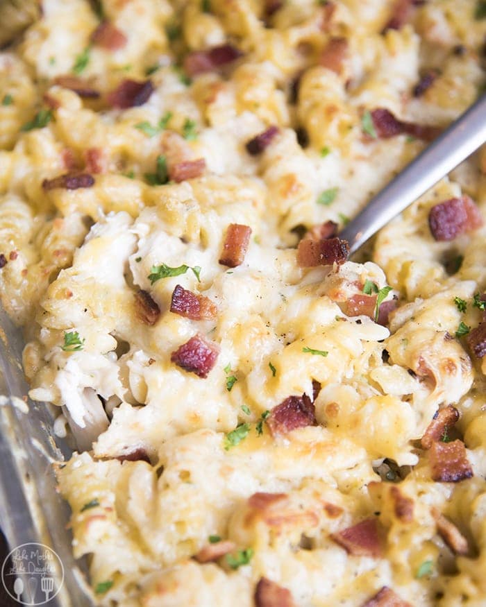 A chicken bacon ranch casserole topped with cheese and bacon pieces.