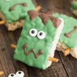 A Frankenstein Rice Krispie treat decorated with candy eyes and green candy melts.