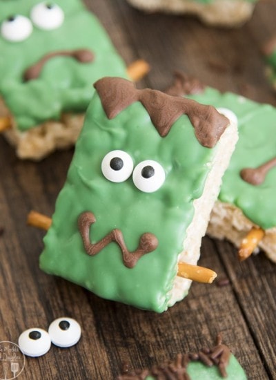A Frankenstein Rice Krispie treat decorated with candy eyes and green candy melts.