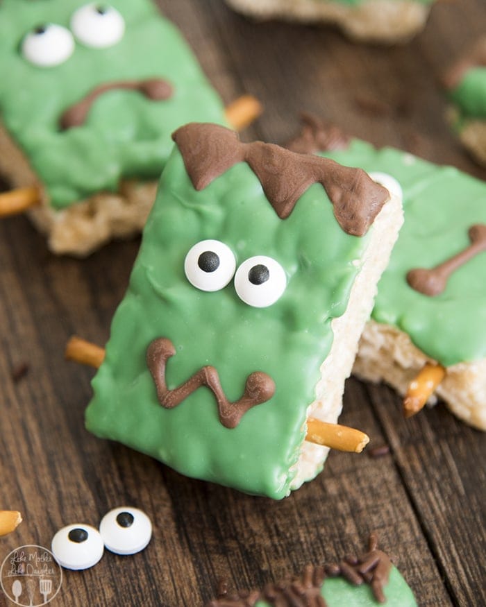 A Frankenstein Rice Krispie treat decorated with candy eyes and green candy melts.