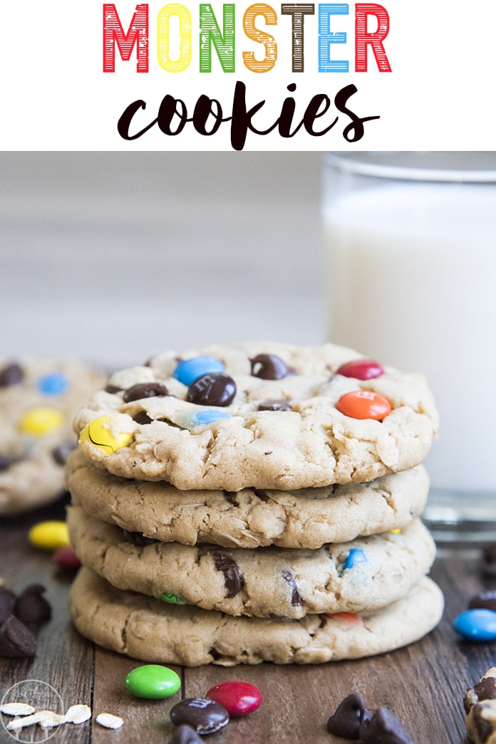 A stack of four peanut butter monster cookies full of chocolate chips and m&ms