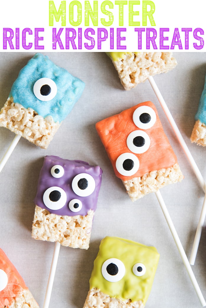 A few monster rice krispie treats arranged together on waxed paper. 