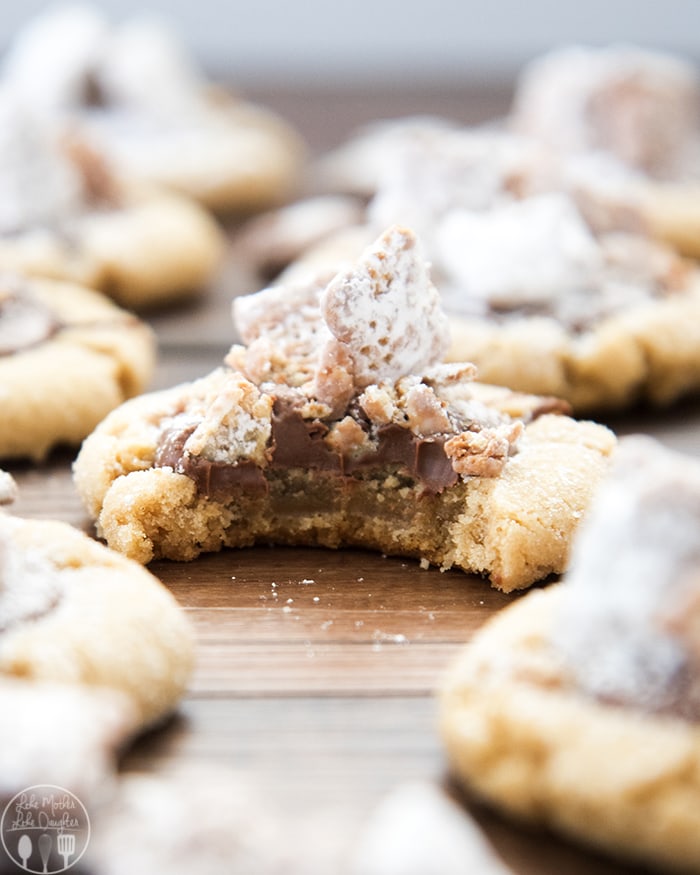 A peanut butter muddy buddy cookie with a bite out of it.