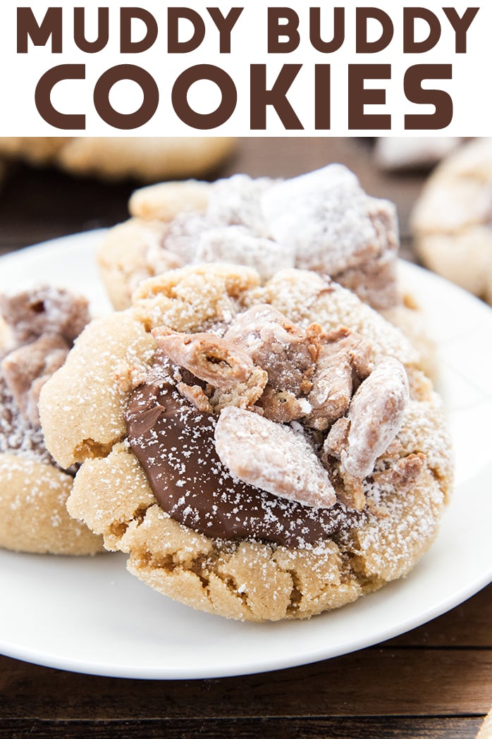 Three muddy buddy topped peanut butter cookies on a white plate.