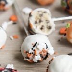 Cookie dough pops decorated with white chocolate and Halloween sprinkles.