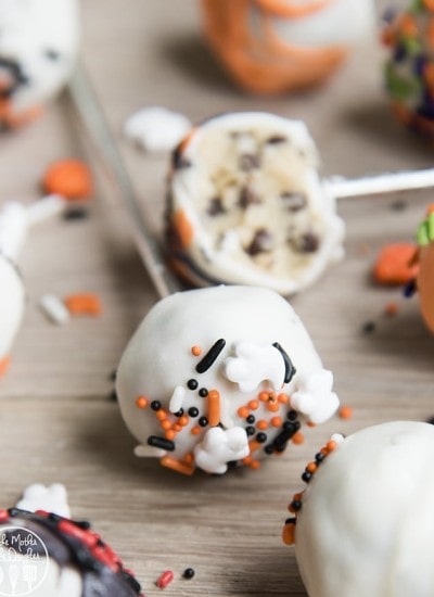 Cookie dough pops decorated with white chocolate and Halloween sprinkles.