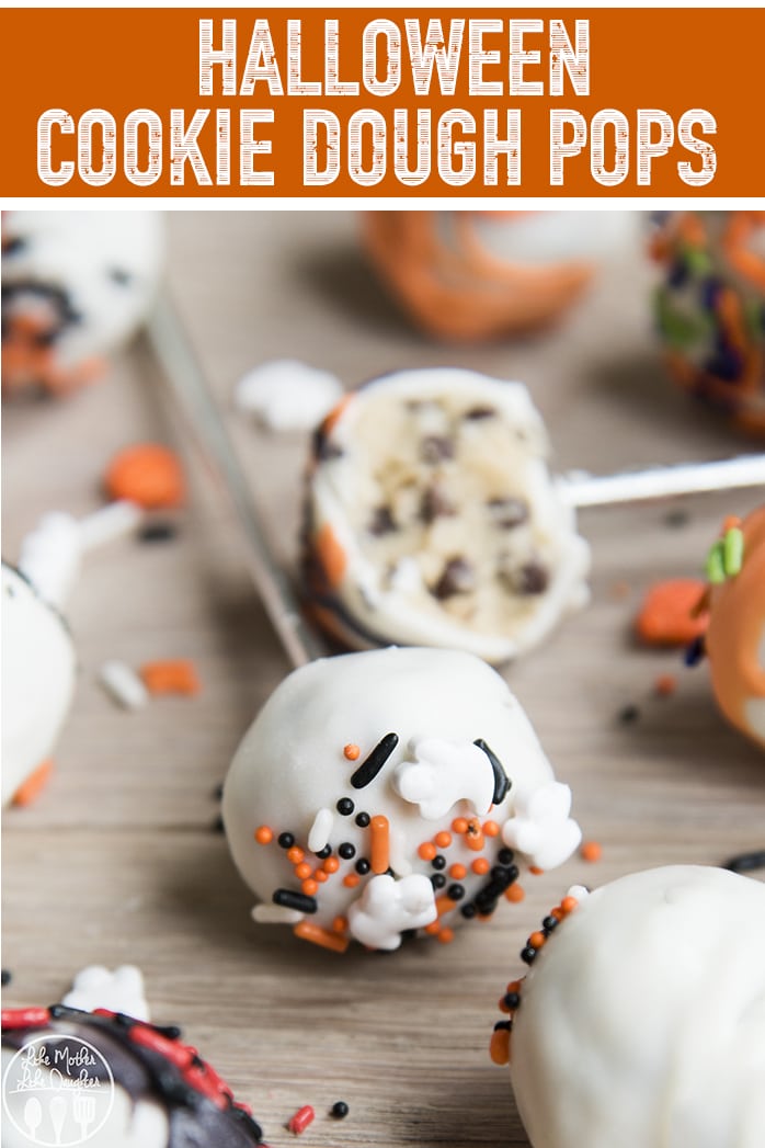 Two cookie dough pops on a stick with white chocolate and Halloween sprinkles. 