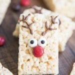 A rice krispie treat decorated with chocolate antlers, candy eyes, and a red m&m nose to look like a reindeer.