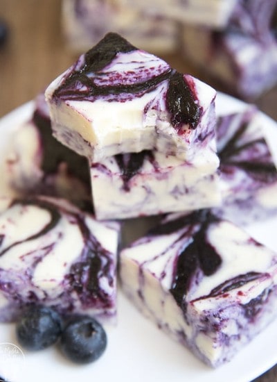 A pile of white chocolate fudge swirled with blueberry sauce.