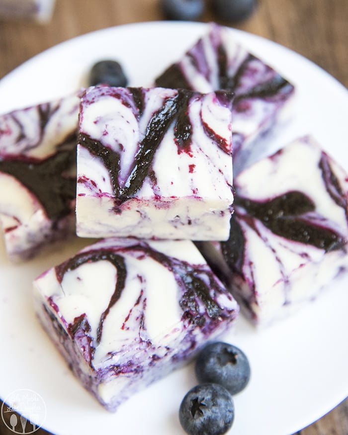 A plate topped with a pile of blueberry and white chocolate swirled fudge.