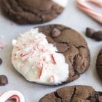 A chocolate peppermint bark cookie dipped in white chocolate and topped with candy cane pieces.