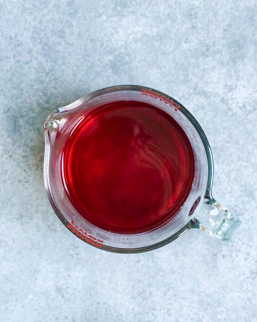 A glass bowl of liquid jello. 