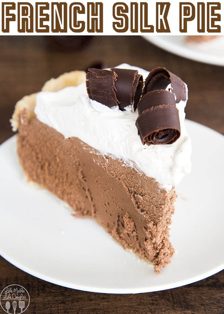 A slice of chocolate french silk pie with whipped cream and chocolate curls on top.