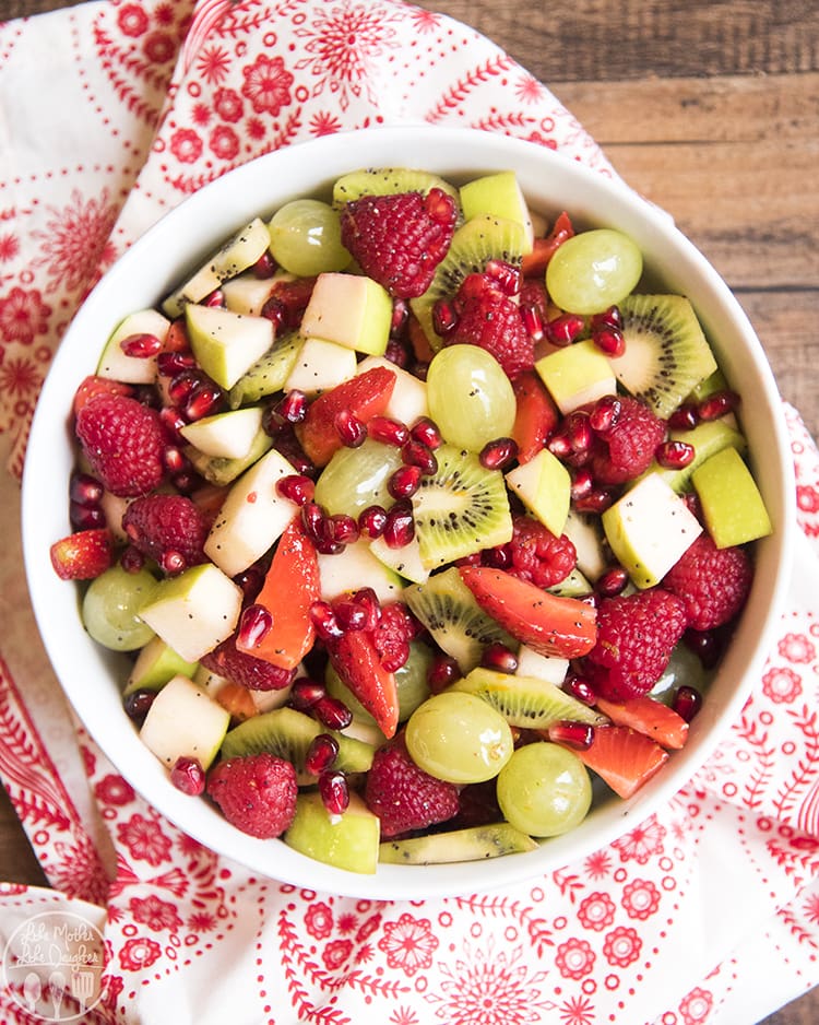 Red and Green Fruit salad with grapes, apples, kiwi, pomegranates, strawberries and raspberries