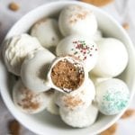 A bowl of gingerbread truffles dipped in white chocolate.