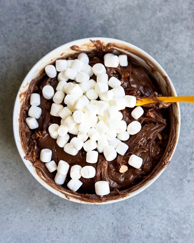 A bowl of microwave fudge with mini marshmallows on top.