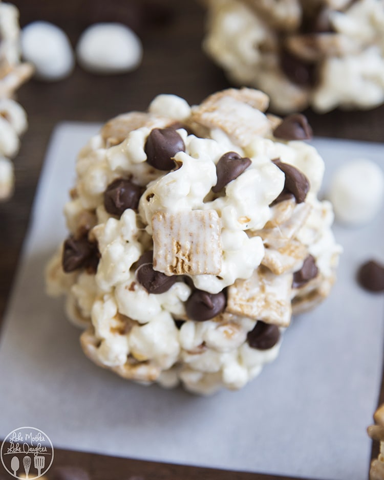 A smores popcorn ball on a piece of parchment paper.