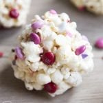 Close up image of valentine's day popcorn balls showing candy and white chocolate.
