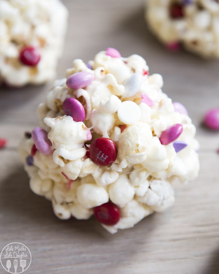 Close up image of valentine\'s day popcorn balls showing candy and white chocolate.