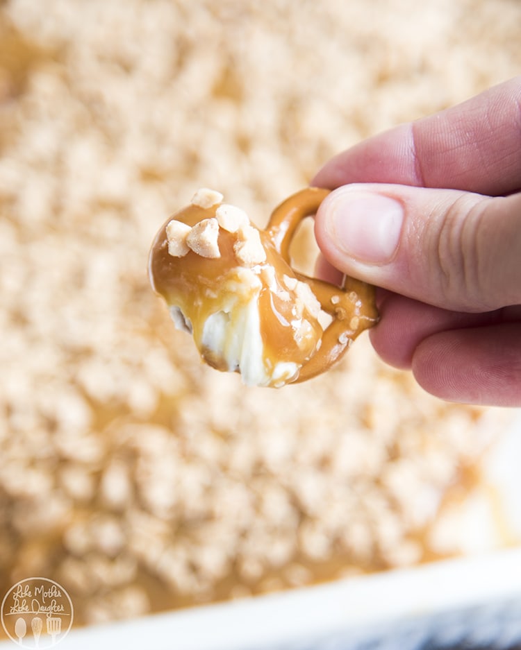 Cream cheese caramel apple dip with a layer of sweetened cream cheese and topped with caramel and toffee bits.