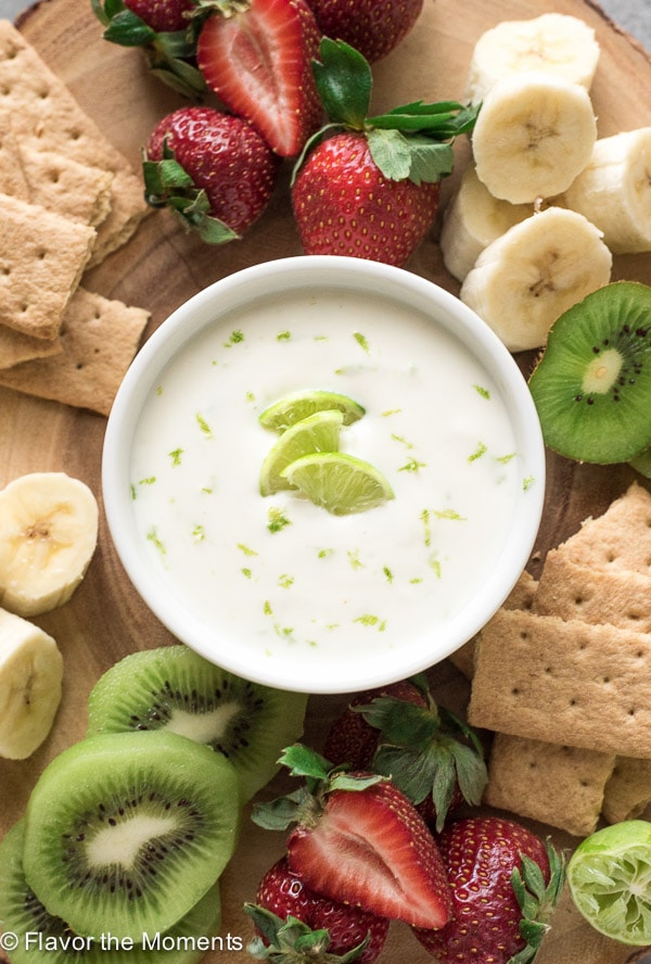 An overhead photo of key lime fruit dip with fruit around it.