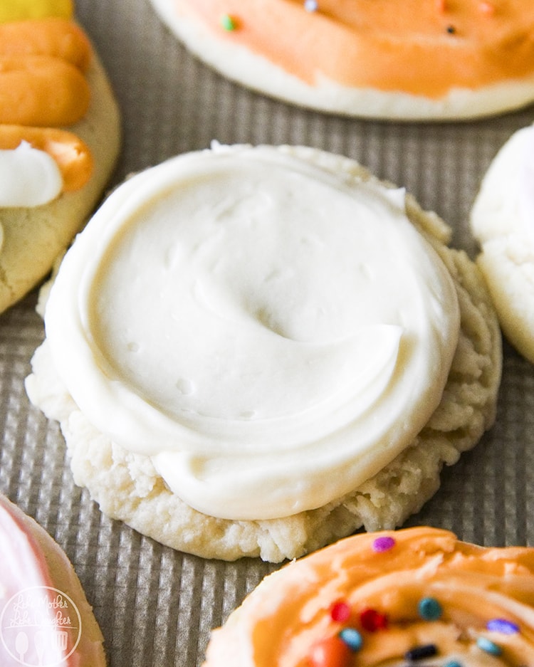 A round sugar cookie topped with white frosting.