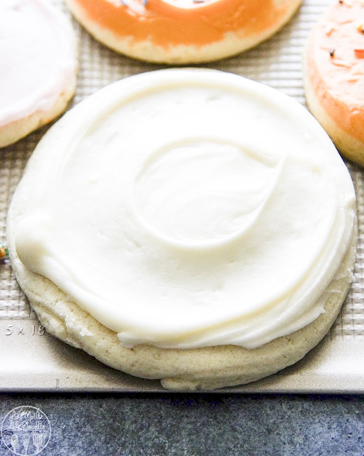 A sugar cookie with white frosting on top.