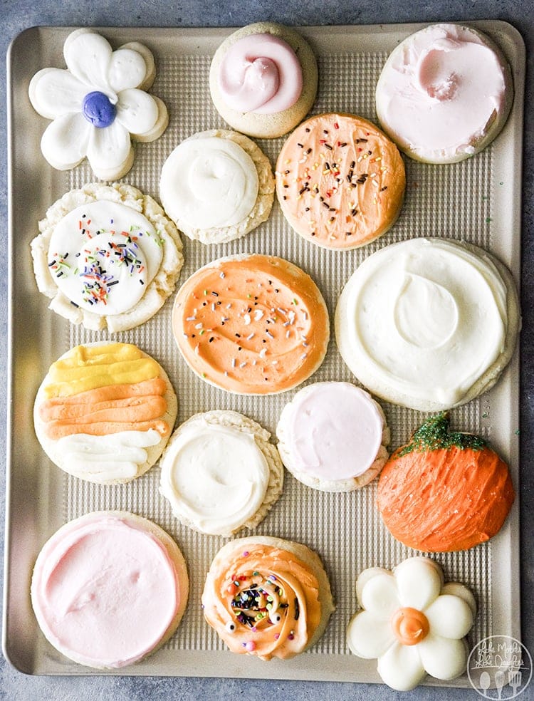 A cookie sheet topped with different types of frosted sugar cookies.