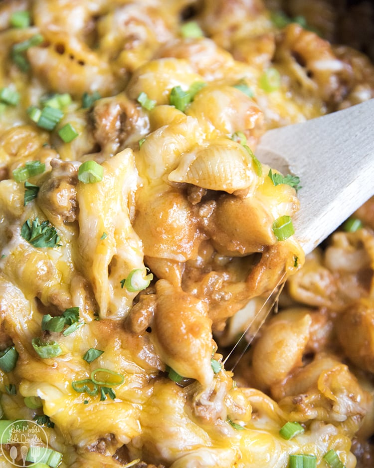 A close up of cheeseburger pasta topped with green onions.