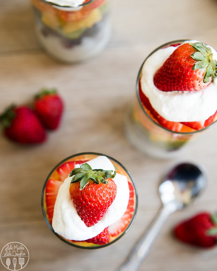 Rainbow Fruit Parfaits topped with cool whip and a strawberry
