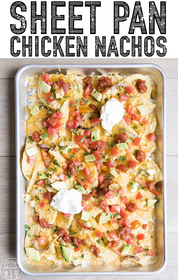 A pan of chicken nachos topped with salsa, avocado, tomatoes, and sour cream.